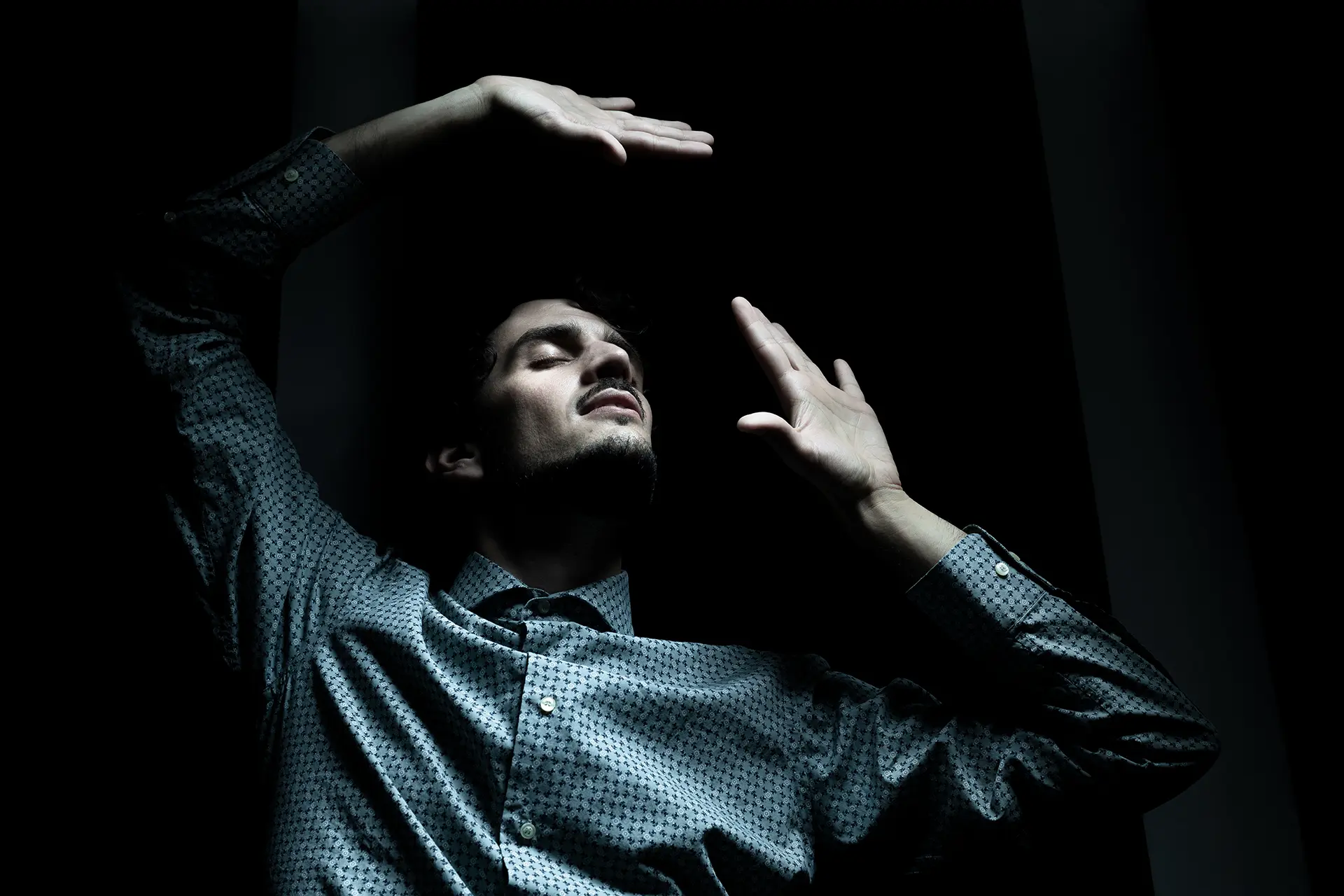 Federico Ercoli in a dramatic pose wearing a dark shirt.