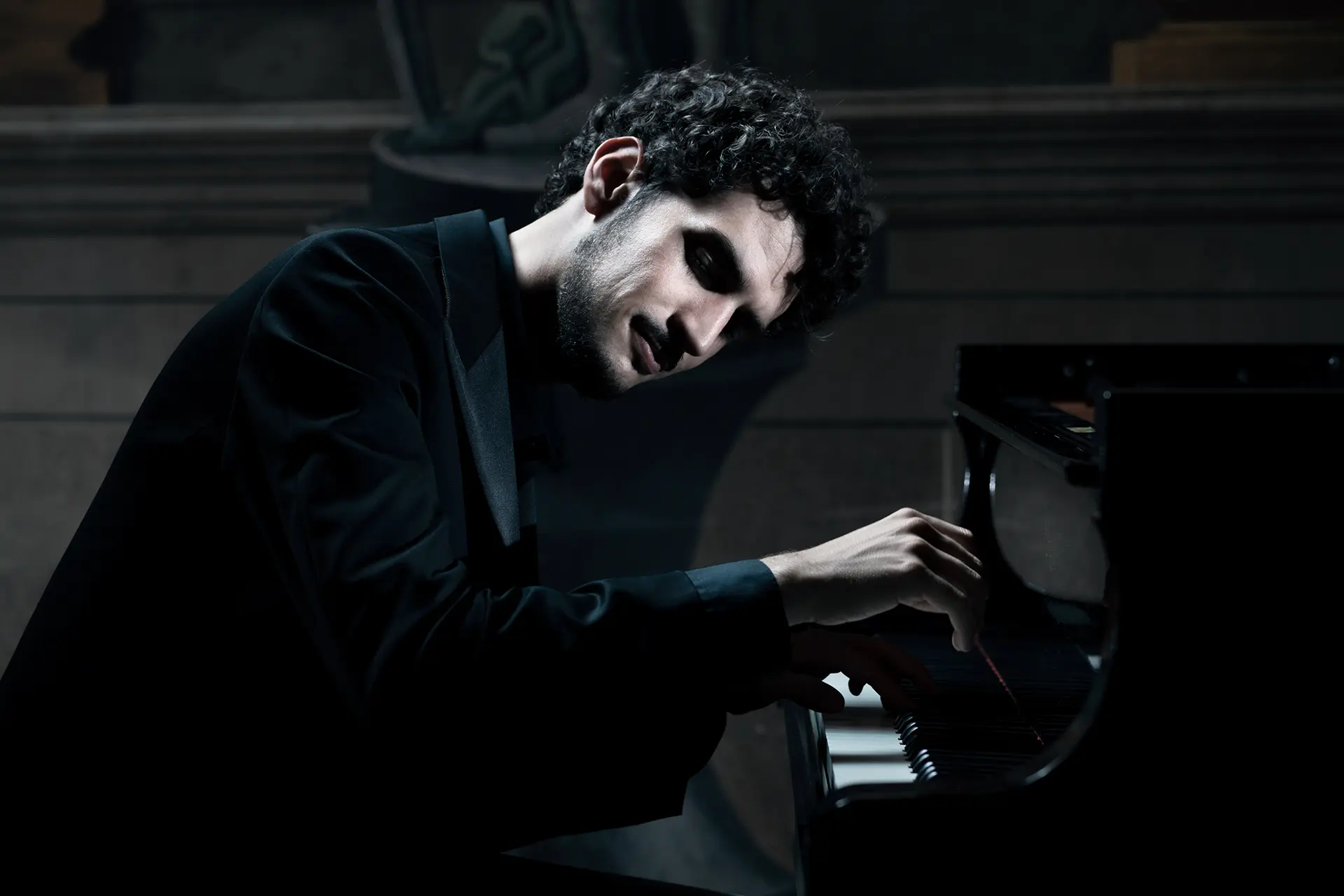 Federico Ercoli playing in soft lighting, showing his passion for music performance and interest in musicological research