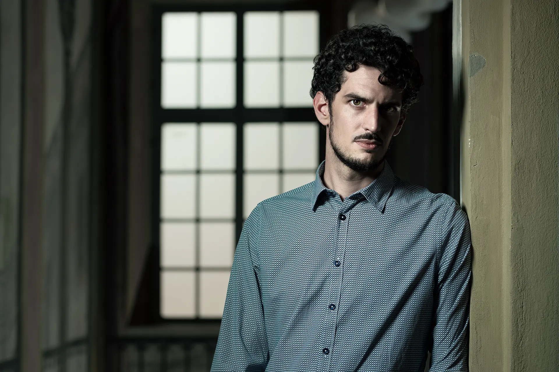 Federico Ercoli in front of a grid-patterned window.